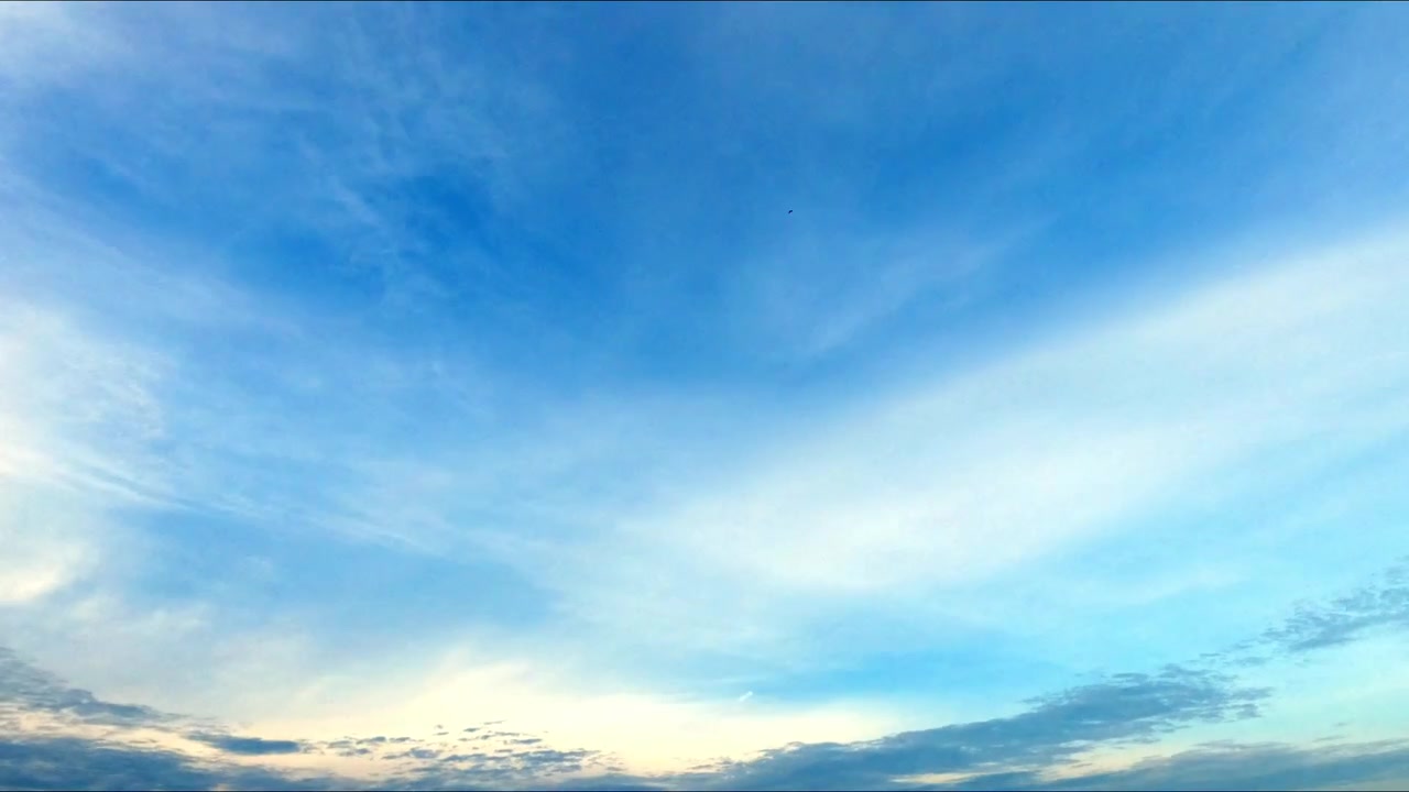 Timelapse of dramatic cloud formations moving across an open sky, creating dynamic natural patterns and changing atmospheric conditions.