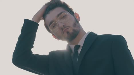 confident-man-poses-at-spring-sunshine-closeup-slow-motion