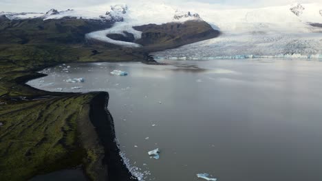 melting glacier in iceland lake during winter, aerial landscape