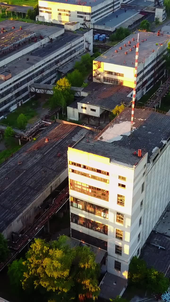 Old Industrial Factory Buildings. Vintage old big factory with closed door and broken windows Vertical video