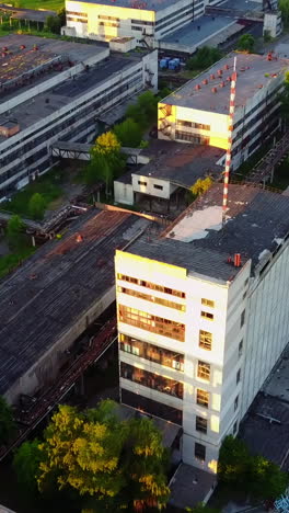old industrial factory buildings. vintage old big factory with closed door and broken windows vertical video
