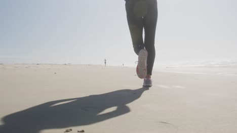 athletic woman running on the beach