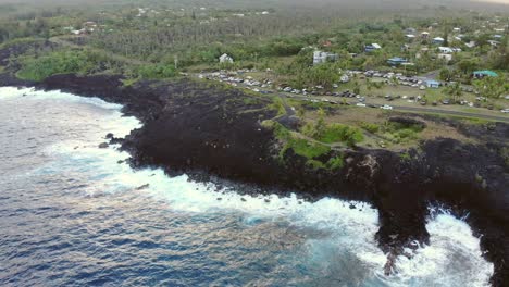 Seaview-and-its-lawn-space-shown-from-the-ocean-flying-in-over-black-cliffs-and-a-gathering-of-people-and-cars-on-a-Sunday-evening-at-sunset