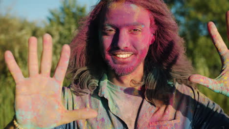 man celebrating holi festival with colorful powder