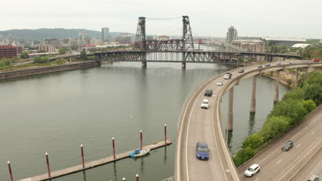 aerial shot over slow moving cars towards a tram going over a bridge portland oregon