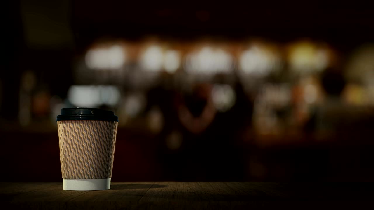Vasos desechables con café y cócteles aparecen en un bucle infinito sobre el mostrador de una barra. La toma de producto perfecta para títulos publicitarios y promociones para cafeterías y restaurantes