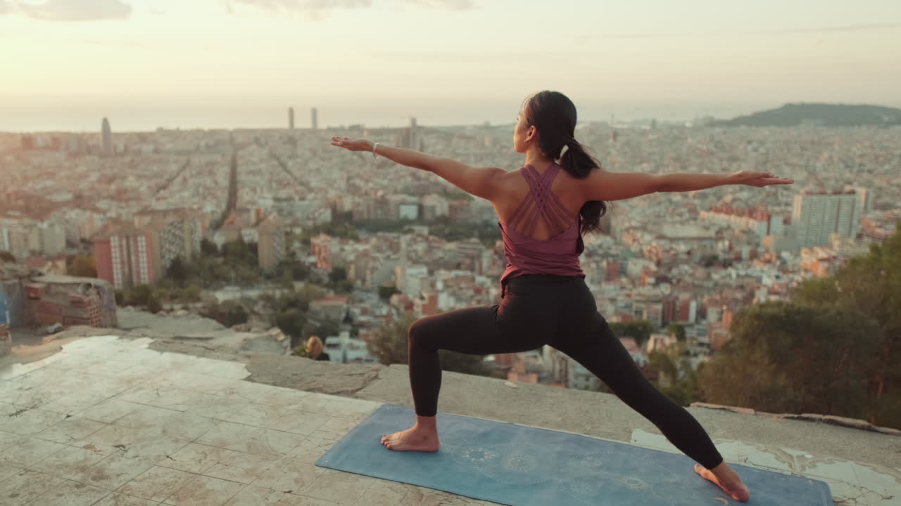 Woman doing yoga with city view