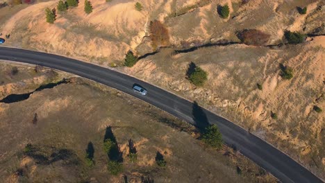 car driving on an open road drone shot