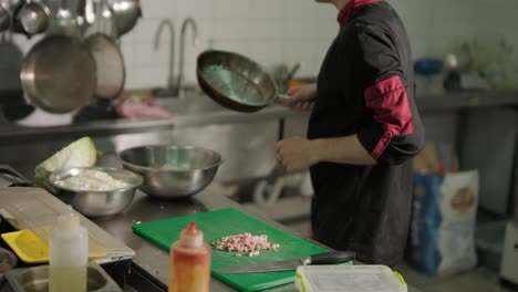 chef preparing caesar salad in a professional kitchen