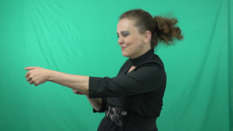 gorgeous lady in green background acting for a charade game - medium shot