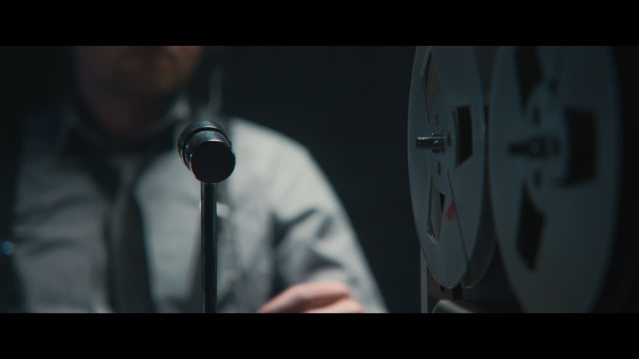 An intelligence officer listens to the wiretap recordings