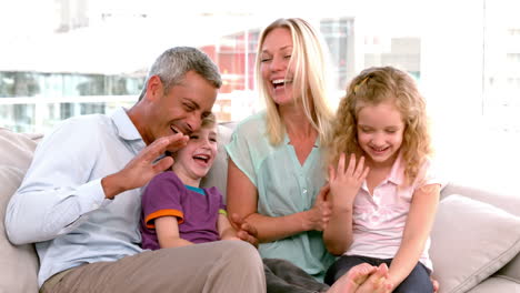 In-slow-motion-happy-family-sitting-on-sofa