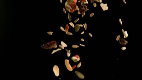 Dry-fruits-falling-against-black-background-4k