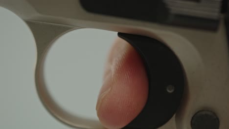 Macro-view-of-finger-gently-pulling-trigger-of-pistol