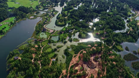 residential properties among ponds and woodland area, drone view