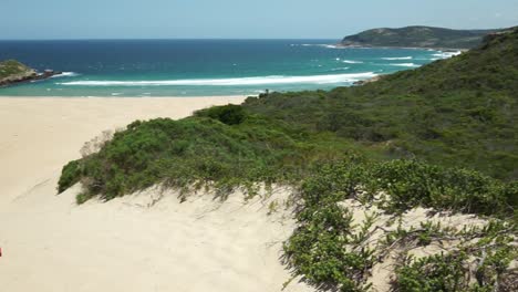 young guy looking out to robberg beach, plettenberg bay, south africa.