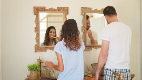 Couple,-bathroom-and-brushing-teeth-in-mirror