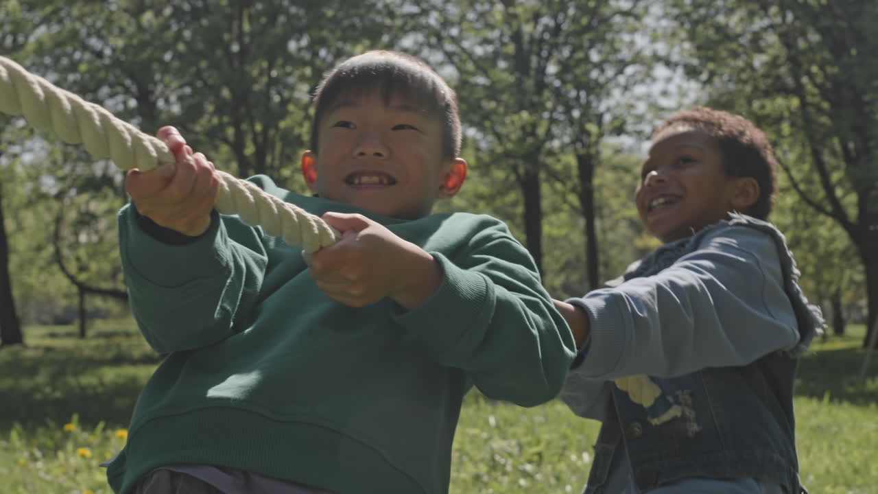 Children playing tug of war outdoors