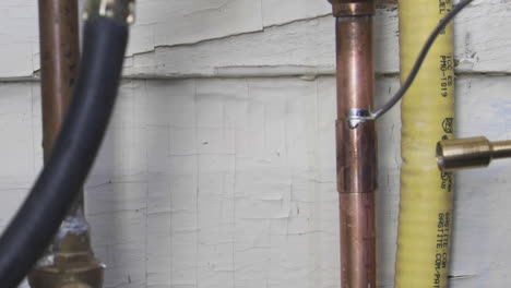 welding the top and bottom of a copper pipe coupler using flux, solder and a propane torch