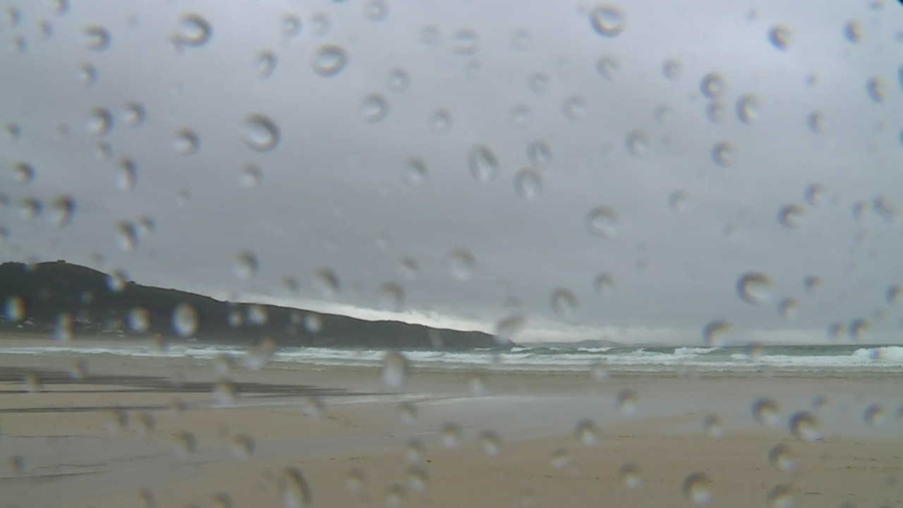 Rainy Beach View Through a Window