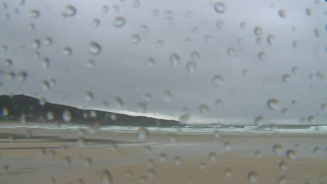 rainy beach view through a window