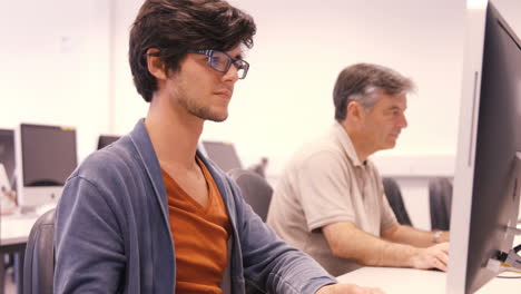 Student-and-teacher-working-on-computer