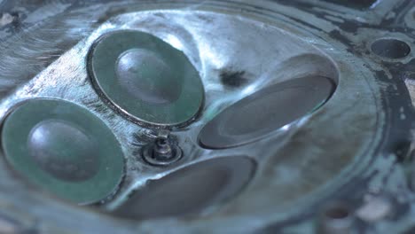 engine valves of a motorbike are shown in detail as they open and close, highlighting the intricate mechanics during maintenance