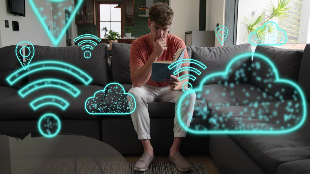 Man tapping tablet on sofa, activating turquoise cloud and Wi-Fi icons while checking tech
