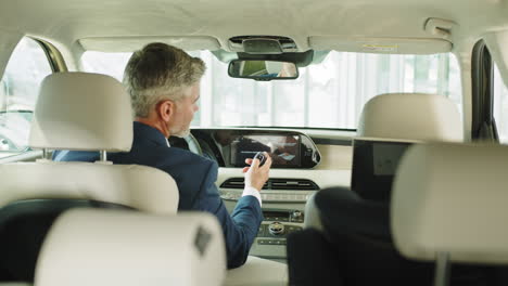 business man in modern car interior