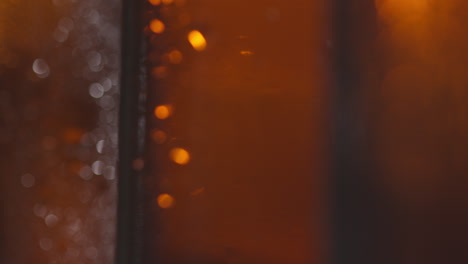 Pull-Focus-Close-Up-Shot-Of-Condensation-Droplets-On-Bottles-Of-Cold-Beer-Or-Soft-Drinks