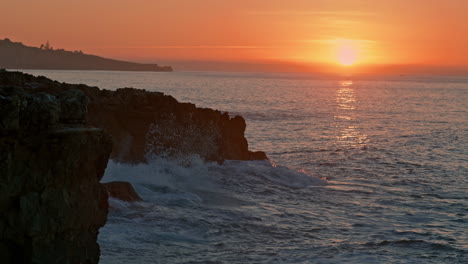 cálido amanecer en el acantilado de la naturaleza. silueta de la colina de la montaña en la playa del mar de la mañana