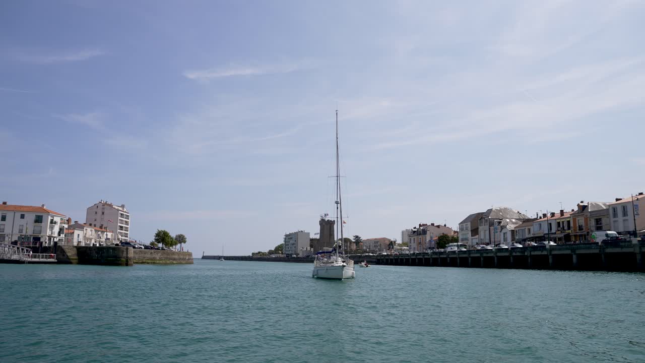 Tall mast sailboat yacht entering the port from the Atlantic ocean at Les Sables D'olonne Western France, View from boat