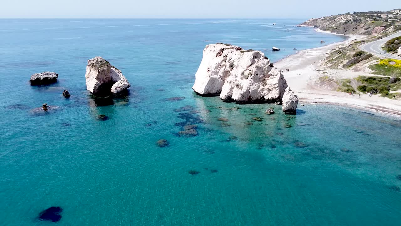 On a beautiful sunny day, enjoy the stunning view of coastal cliffs rising from the clear blue waters of Cyprus. The natural landscape invites relaxation and exploration