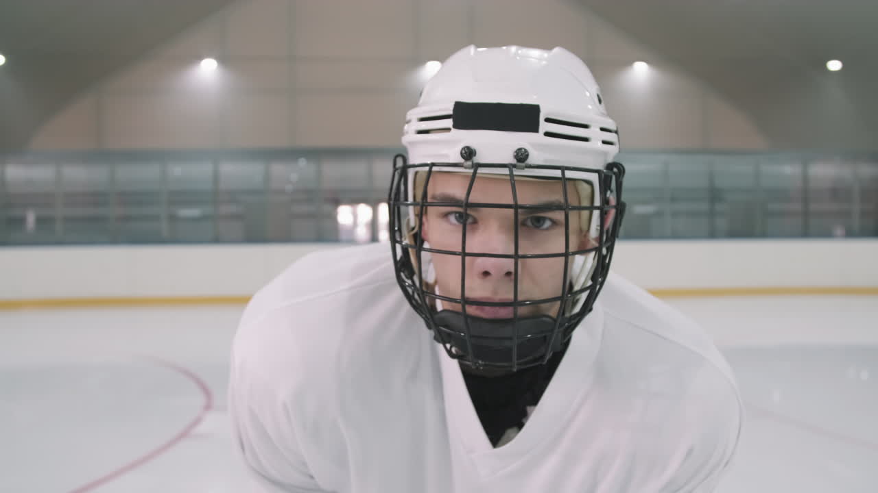 Young Male Hockey Player In Helmet With Cage