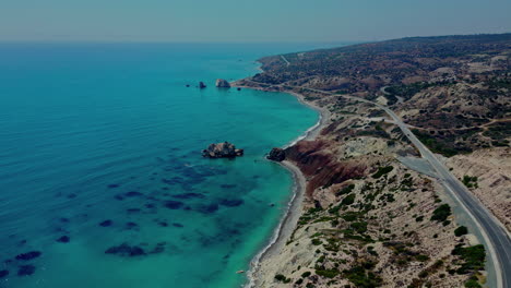 aerial drone view of a beautiful highway with a coastline overlooking the blue ocean of cyprus