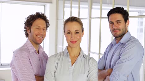 confident businesspeople posing with arms crossed