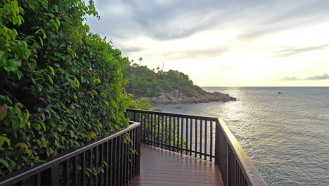 beautiful view of the seaside wooden walkway with a metal railing