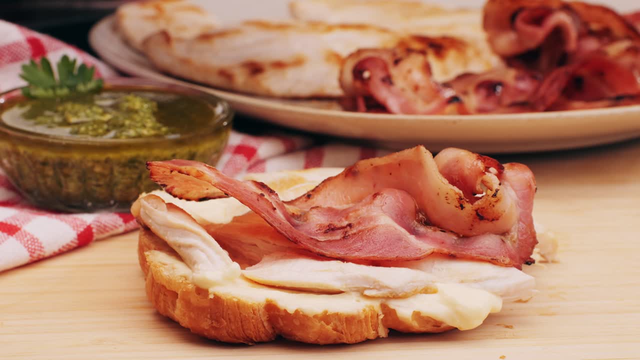 Croissant with jamon ham, Salmon, in Modern Cafe, Top View of Healthy Breakfast in Cafe. English breakfast: fried egg, bacon toast on sandwich.