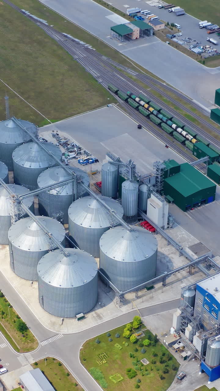 Big steel grain elevator warehouse. Modern agricultural architecture landscape. Vertical video