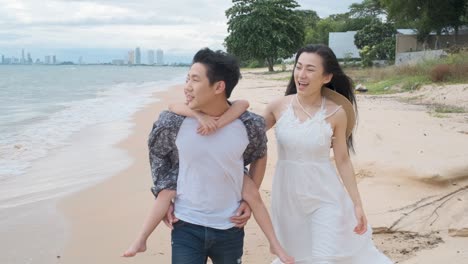 asian family walking at beach with kids happy vacation concept