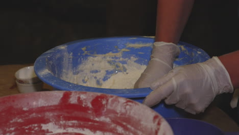 Hands-Of-Baker-Mixing-Flour-And-Adding-Water-For-Preparation-Of-Dough-For-Khinkali-Georgian-Dumpling---close-up