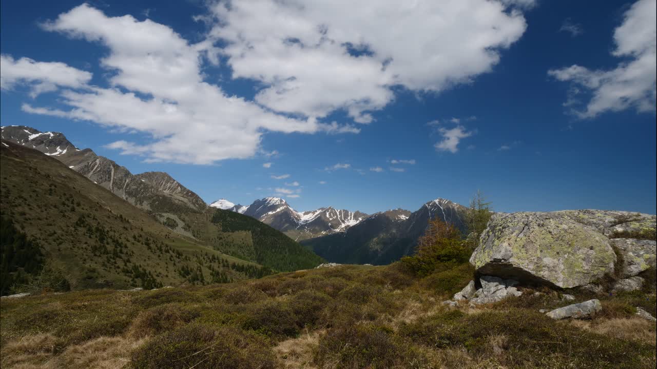 Timelaps shot of fast moving clouds in the mountains in spring, Dolomites, Italy