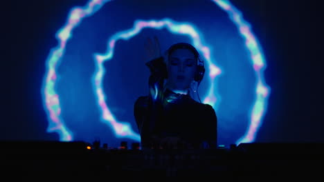 a female dj performing on stage at a nightclub