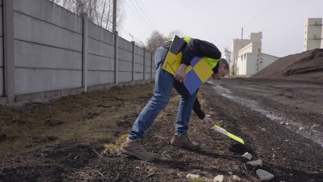 Man-setting-down-a-drone-landing-pad-for-their-work---slow-motion