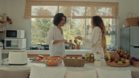 couple cooking and preparing fresh tropical fruits in a kitchen