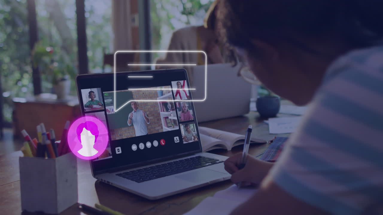 Participating in virtual meeting, person taking notes with laptop at home
