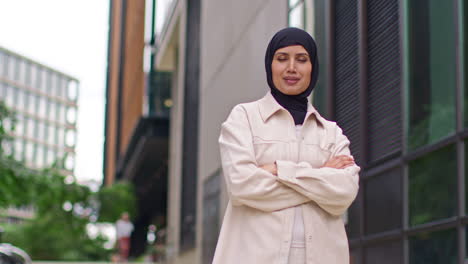 Portrait-Of-Smiling-Muslim-Businesswoman-Wearing-Hijab-With-Business-Suit-Going-To-Work-Standing-Outside-Modern-Office-Buildings-2