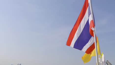 beautiful view over bangkok city skyline with thai national flag