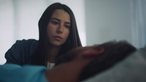 Worried-woman-comforting-patient-after-surgical-operation-in-hospital-closeup.