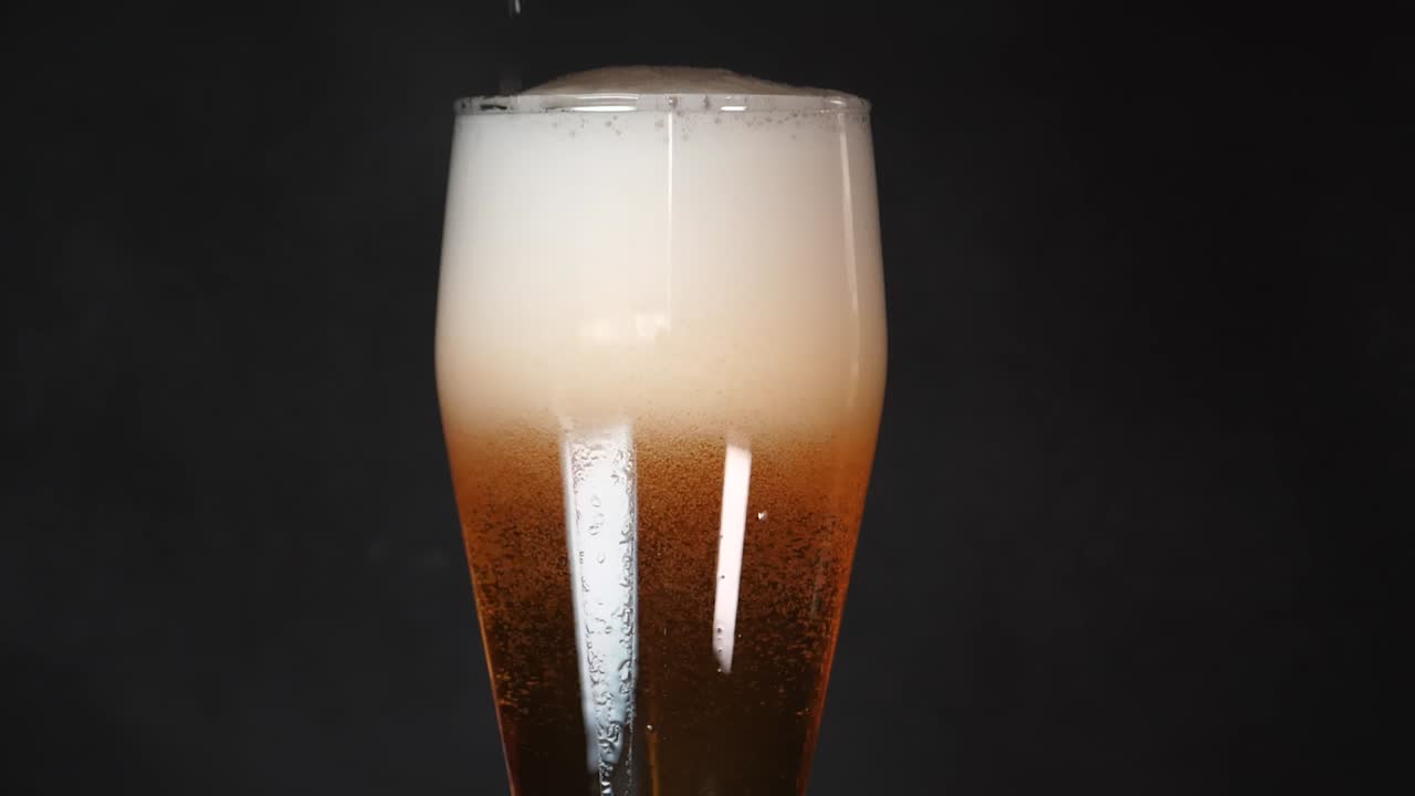 Fermented tasty beer, crafted beverages, fizzy amber liquid, close-up